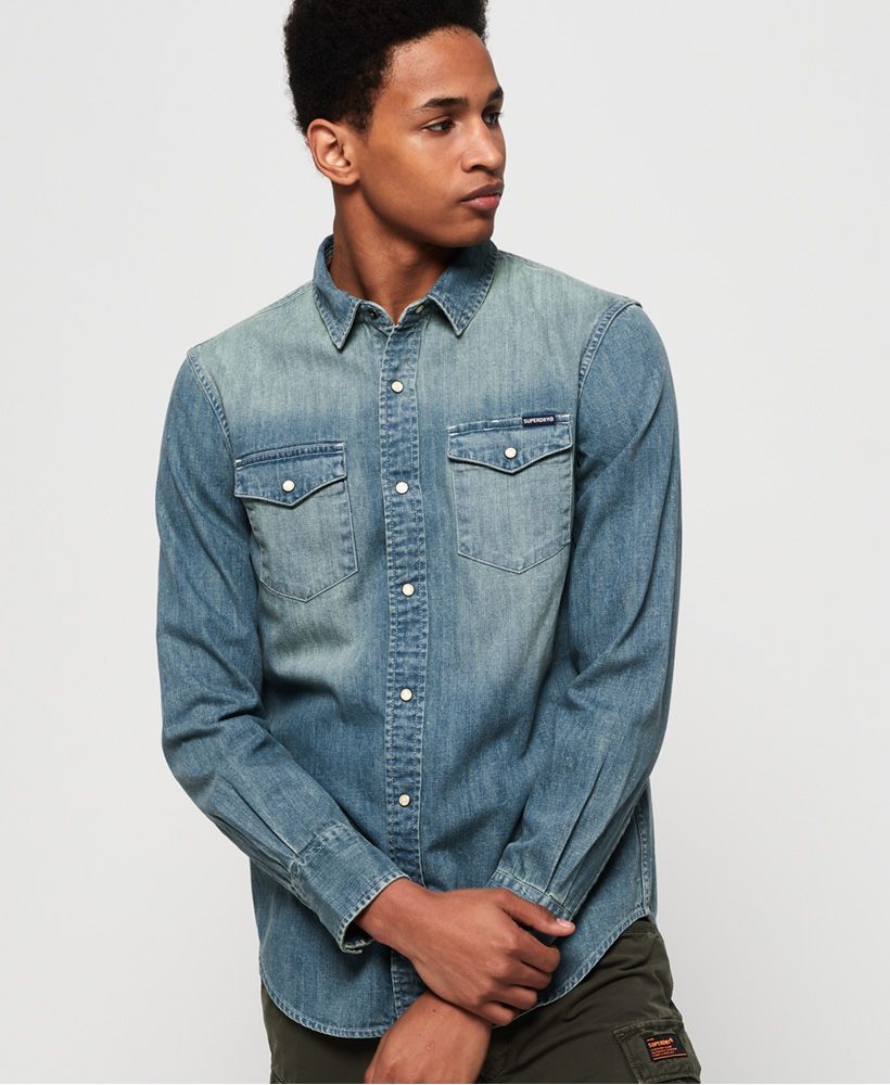 Superdry men's Resurrection long sleeve shirt. This classic denim shirt features a popper fastening, twin chest pockets and popper fastened cuffs. Completed with a logo tab on one pocket, why not wear loose over a plain t-shirt and chinos for a casual, relaxed look.