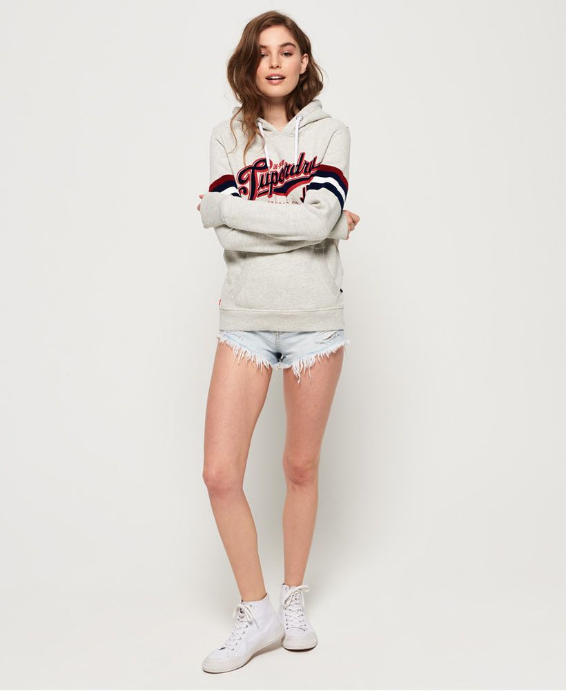 Superdry women’s Standard flock hoodie. Breathe life into your new season with this hoodie, a great all-rounder that is appropriate to wear to many occasion. This hoodie features draw cord hood, ribbed cuffs and hem, large front pocket as well as a Superdry logo on the chest with stripe detailing on the arms. Note the Superdry tab in the side seam and the signature orange stitch in the other for those perfect finishing touches.