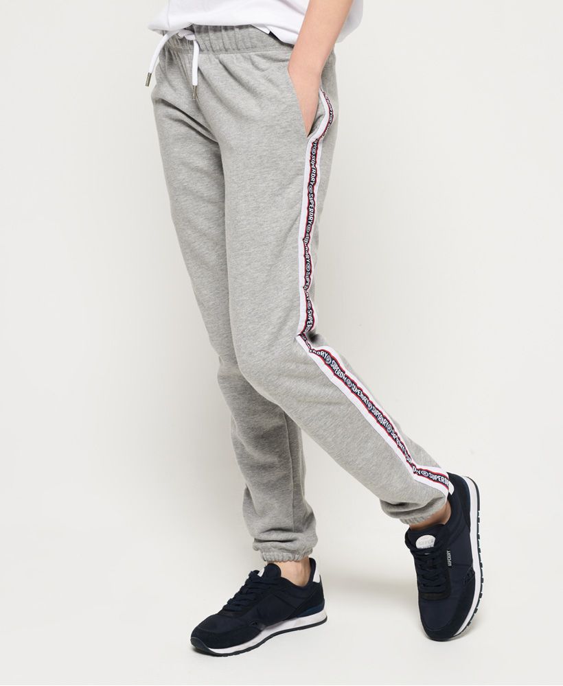 Superdry women's Alicia joggers. These joggers feature a drawstring adjustable waist, a soft fleece lining, two front pockets and elasticated cuffs. Finished with Superdry logo detailing down the sides.Relaxed fit