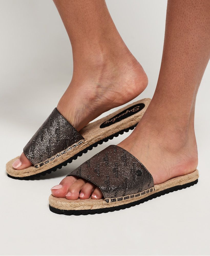 Superdry women's Maya espadrilles. The ultimate slip on summer shoe, these espadrilles feature a wide front strap and logo detailing on the sole. These shoes will be the perfect finishing touch to any summer outfit, from shorts and a t-shirt to a floral dress and denim jacket.