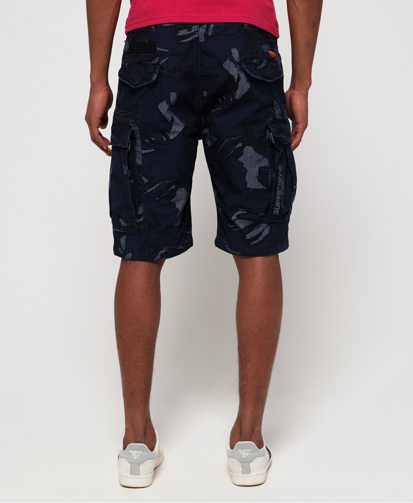 Superdry men's Parachute cargo shorts. This is the perfect choice for a fresh and current wardrobe, featuring a seven pocket design, a main zip and button fastening and a variety of military inspired badges. Finished with a Superdry logo badge on the back and one on a front pocket.