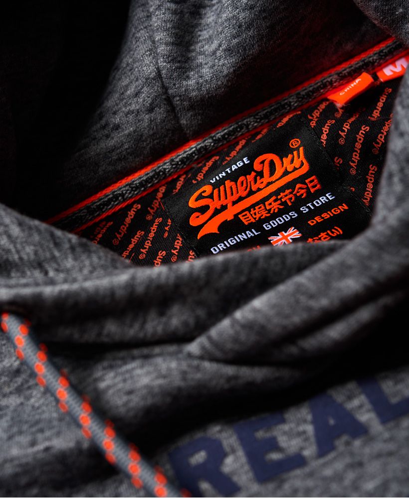 Superdry men's Vintage Logo neon tip hoodie. Desgined with your comfort in mind, this overhead hoodie features a drawstring hood, super soft lined body and large logo graphic on the chest. The Vintage Logo neon tip hoodie has been completed with a number graphic on one sleeve, contrast piping along the cuffs and hem, and logo badge on the pocket.