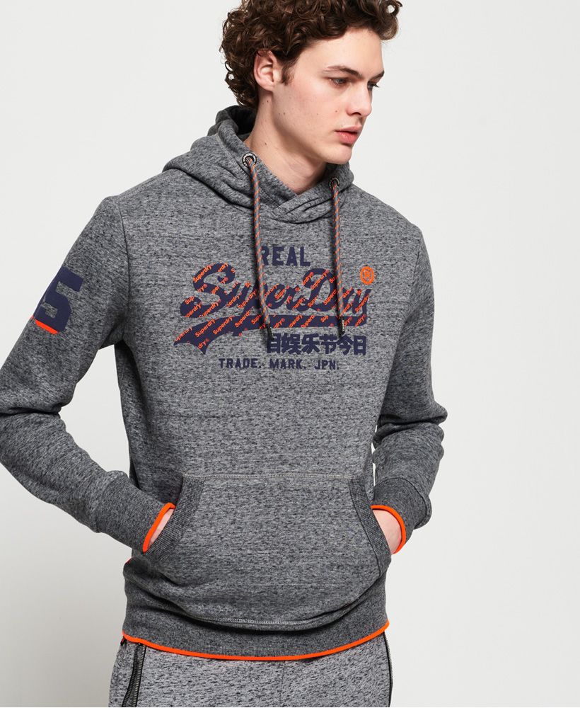 Superdry men's Vintage Logo neon tip hoodie. Desgined with your comfort in mind, this overhead hoodie features a drawstring hood, super soft lined body and large logo graphic on the chest. The Vintage Logo neon tip hoodie has been completed with a number graphic on one sleeve, contrast piping along the cuffs and hem, and logo badge on the pocket.