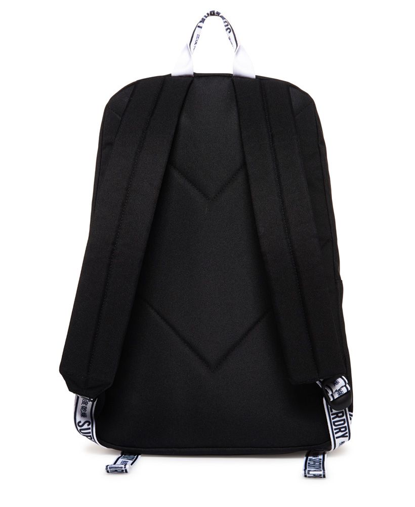 Superdry women's Hayden backpack. Tap into the monochrome trend this season with the Hayden backpack. Classic in style, this backpack features two main compartments, one with a padded laptop sleeve, and smaller outer compartment, perfect for keeping your smaller essentials within easy reach. A top carry handle make this a great grab and go backpack, while adjustable shoulder straps and a padded back provide comfort and support. The Hayden backpack is completed with a rubber logo badge on the front, subtle logo detailing across the outer compartment and branding on the carry handle and straps.16.5 litre approximate main compartment capacity.H 43.5cm x W 21.5cm x D 15cm