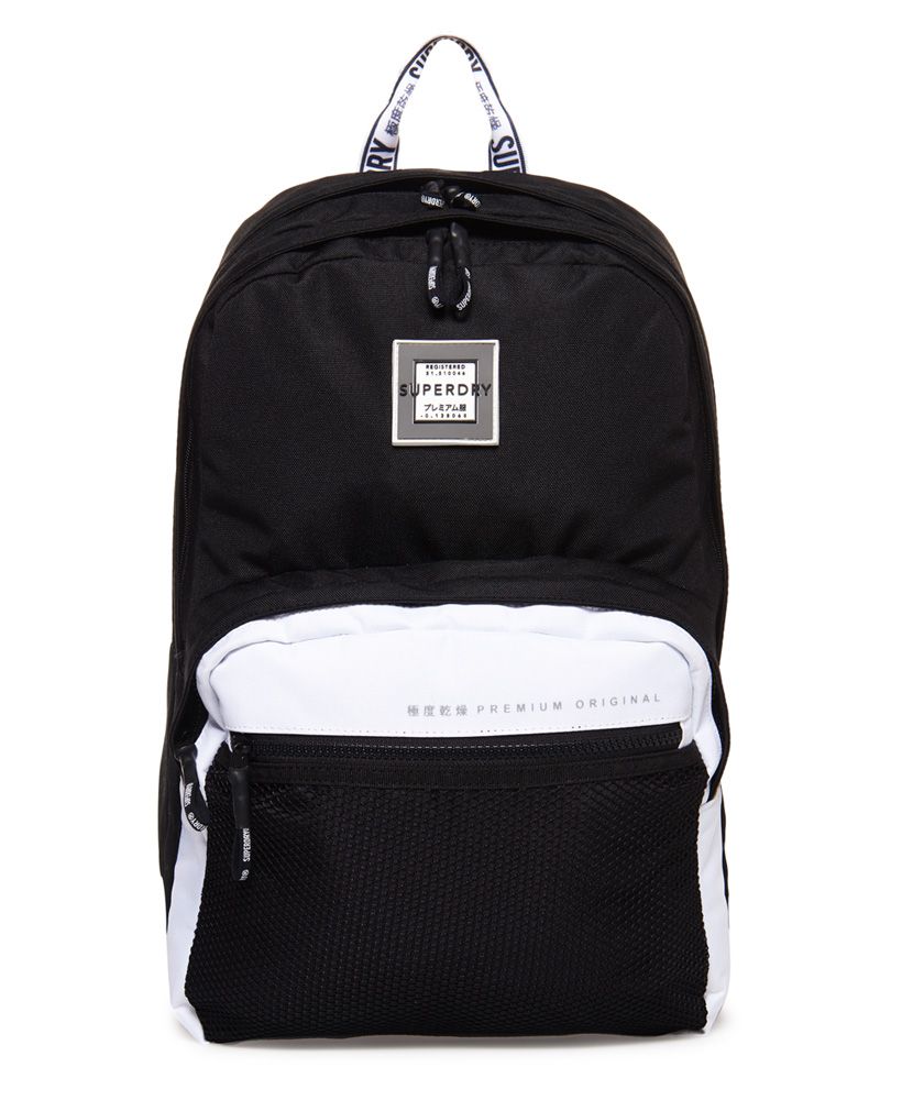 Superdry women's Hayden backpack. Tap into the monochrome trend this season with the Hayden backpack. Classic in style, this backpack features two main compartments, one with a padded laptop sleeve, and smaller outer compartment, perfect for keeping your smaller essentials within easy reach. A top carry handle make this a great grab and go backpack, while adjustable shoulder straps and a padded back provide comfort and support. The Hayden backpack is completed with a rubber logo badge on the front, subtle logo detailing across the outer compartment and branding on the carry handle and straps.16.5 litre approximate main compartment capacity.H 43.5cm x W 21.5cm x D 15cm