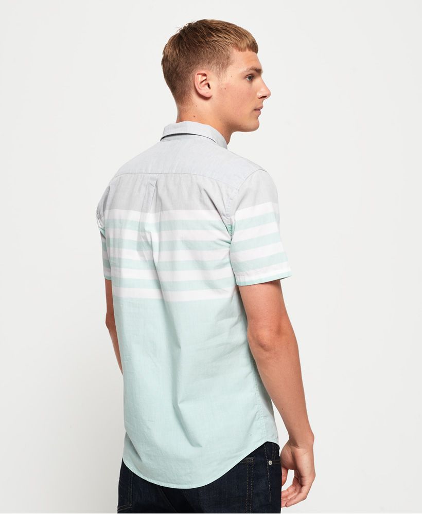 Superdry men's International Poplin short sleeve shirt. This classic button down shirt features short sleeves, a curved hem and logo badge on the placket. Completed with a logo badge on the side seam, pair with chinos and trainers for a smart yet casual look.