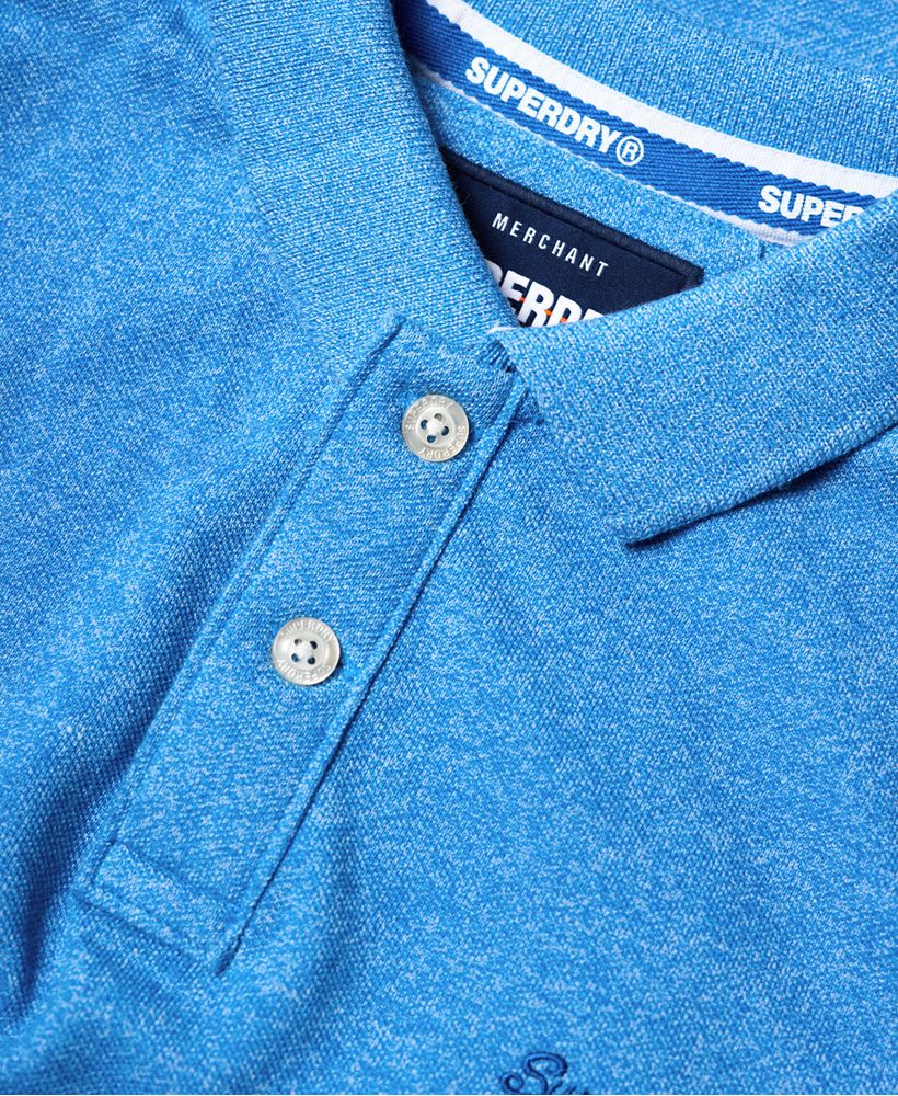 Superdry men's Classic pique polo shirt. Refresh your wardrobe this season with the Classic pique polo shirt, featuring a two button fastening, split side seams and embroidered logo design on the chest. The polo shirt is completed with a number graphic on one sleeve and small logo tab on the hem.Slim fit
