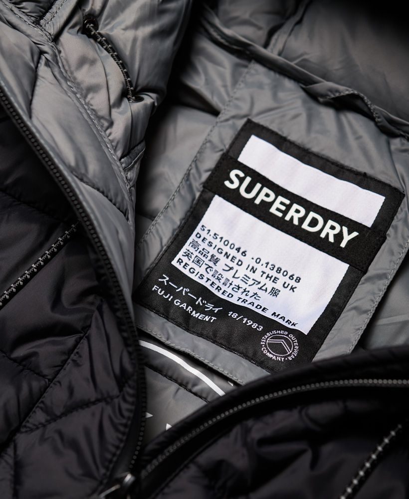 Superdry women's Eclipse hooded Fuji jacket. Update your outerwear this season with this classic Fuji jacket, featuring a bungee cord hood, zip fastening and two front pockets, both with a zip fastening. This jacket also benefits from a bungee cord adjustable hem and is completed with a subtle logo design on the sleeve and branded zip pulls for a premium finish.