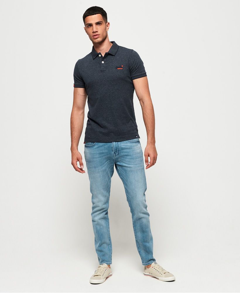 Superdry men's jersey polo shirt from the Orange Label range. This lightweight, cotton polo shirt features a two button fastening, split side seams and an embroidered version of the Superdry logo on the chest. The jersey polo is completed with a logo tab on one sleeve and on the hem.Slim fit
