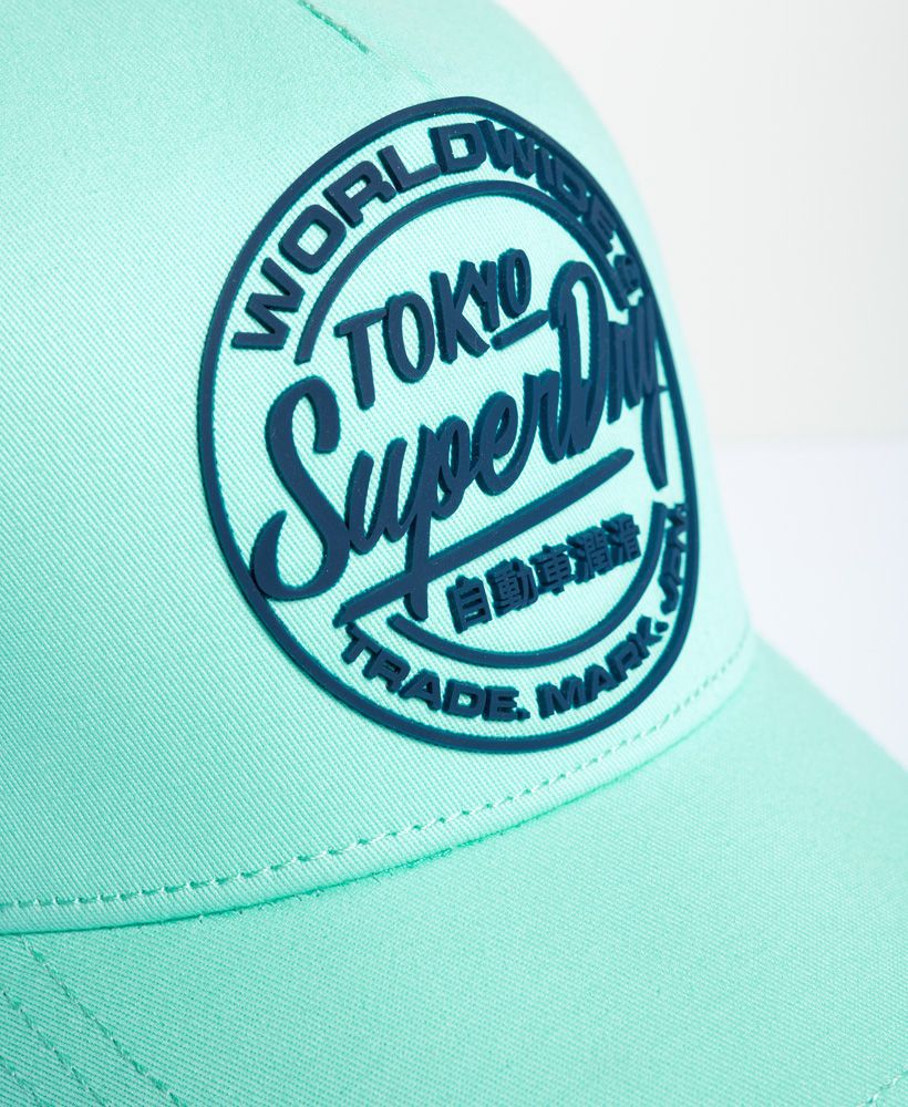 Superdry men's Ticket Type cap. Finish your look this season with the Ticket Type cap, featuring an adjustable fastening for your perfect fit and completed with a high build logo design on the front.