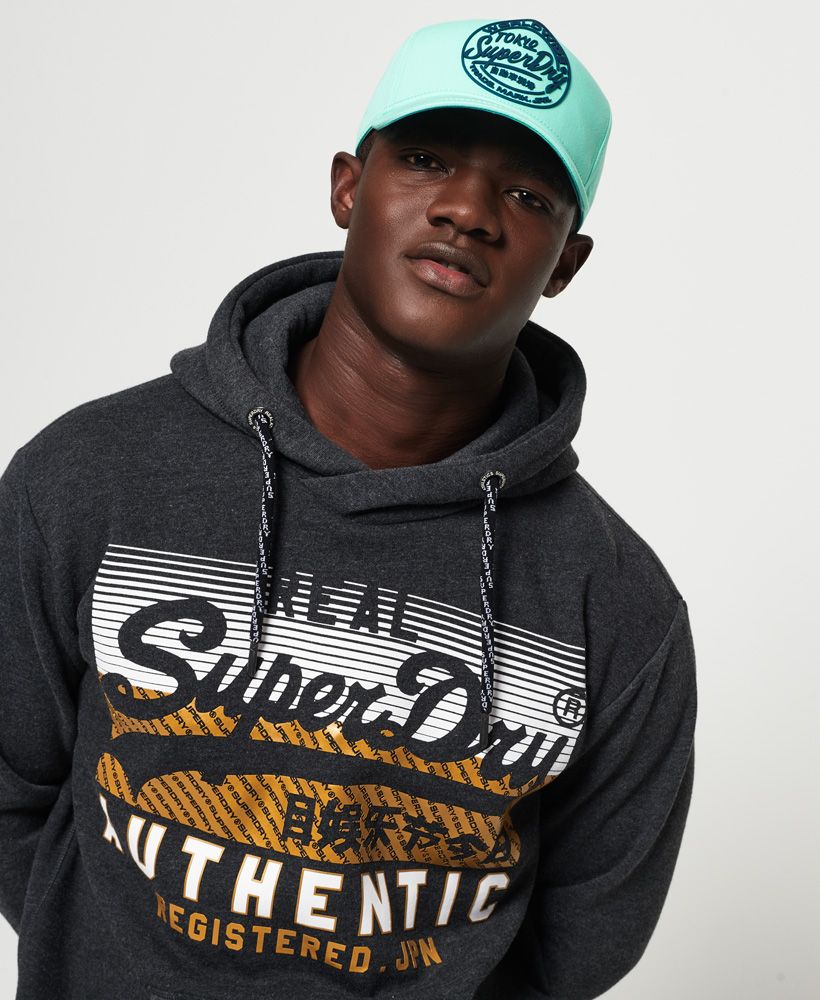 Superdry men's Ticket Type cap. Finish your look this season with the Ticket Type cap, featuring an adjustable fastening for your perfect fit and completed with a high build logo design on the front.