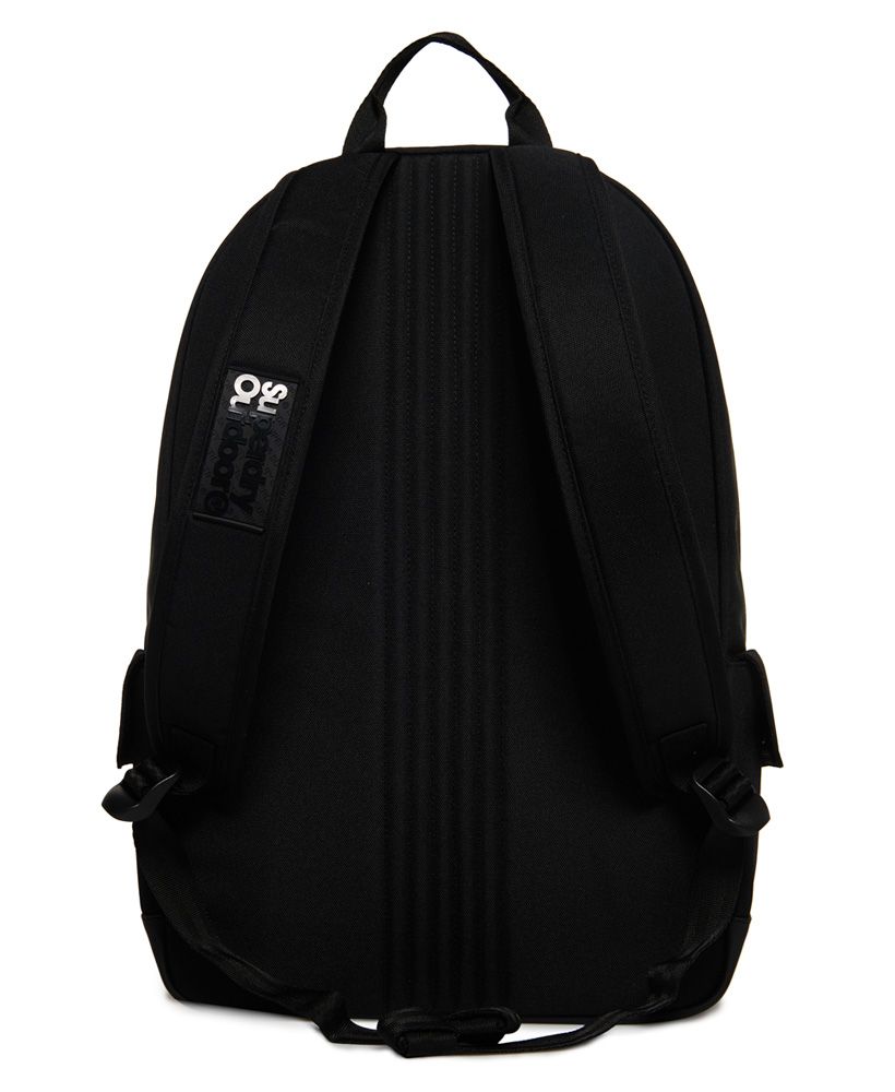 Superdry men's Holographic Lineman Montana rucksack. This classically styled rucksack features a large zip fastened main compartment, a top grab handle and padded back and straps. This rucksack also features an outer zip fastened compartment and two side pockets with popper fastenings. The rucksack is finished with a holographic effect Superdry logo on the front and a silicone logo badge on one strap. 21 litre approximate main compartment capacity.H 46cm x W 30.5cm x D 13.5cm