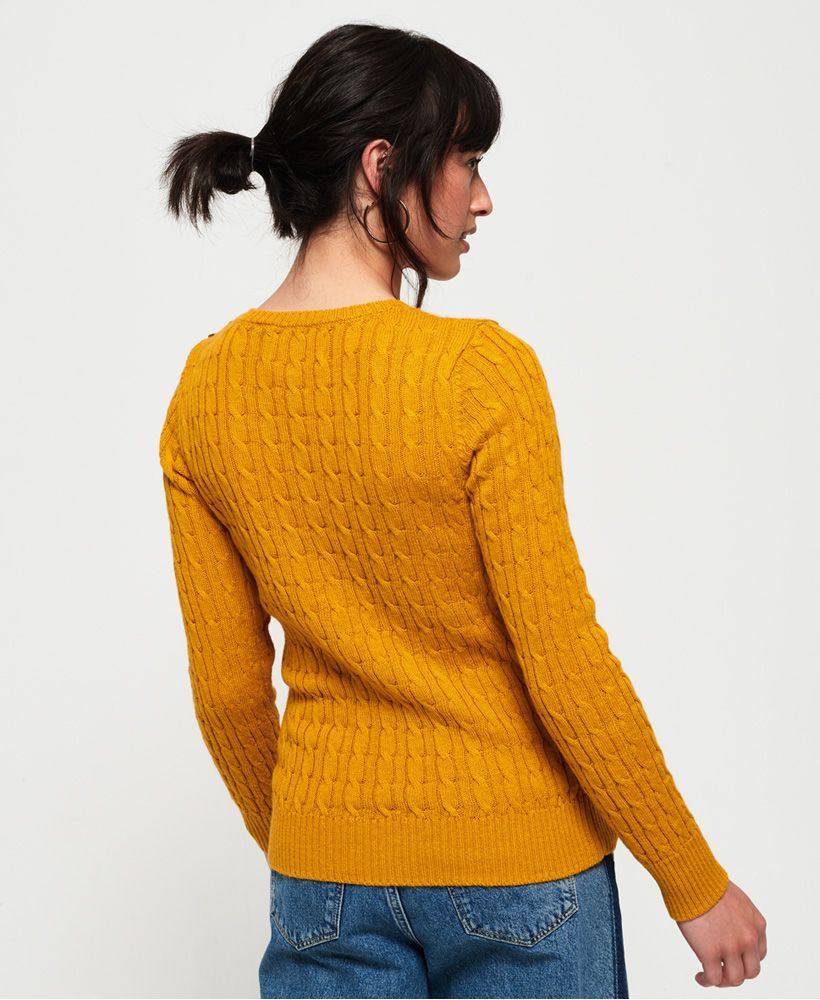 Superdry women's Croyde cable knit jumper. This soft cable knit jumper features a crew neck, button detailing at the shoulder and is completed with a small logo badge above the hem. Pair with a denim skirt and boots for an effortless, everyday outfit.