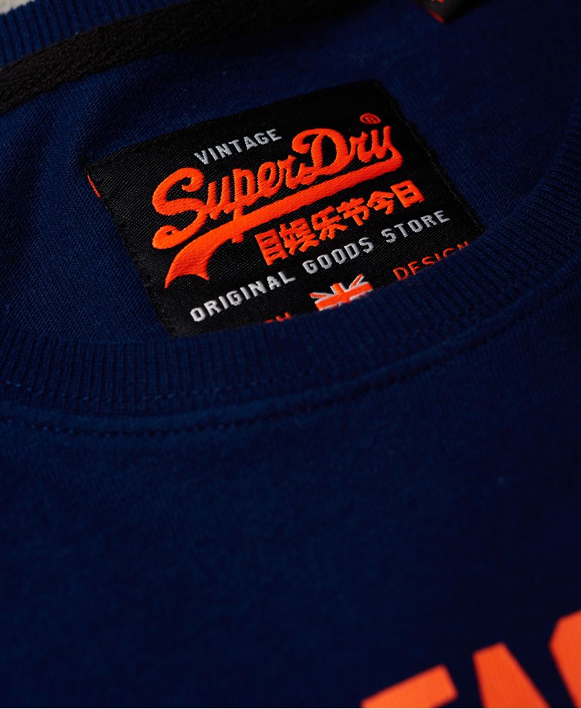 Superdry men's Shirt Shop split panel t-shirt. This long sleeve t-shirt features a panel design with logo taping across the chest, a crew neck and large logo graphic on the front. Style with jeans and trainers for a relaxed yet stylish look.