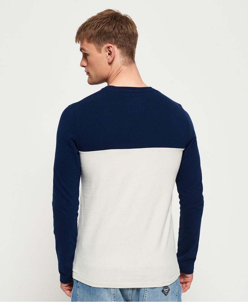 Superdry men's Shirt Shop split panel t-shirt. This long sleeve t-shirt features a panel design with logo taping across the chest, a crew neck and large logo graphic on the front. Style with jeans and trainers for a relaxed yet stylish look.