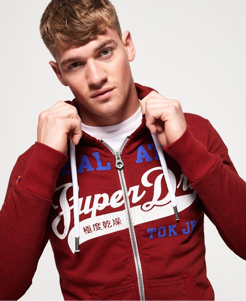 Superdry men’s Heritage Classic zip hoodie. This zip hoodie features a draw cord adjustable hood, a Superdry logo across the chest in a cracked print and a Superdry tab on the cuff. The hoodie has been finished with ribbed cuffs and hem for a flattering fit and two front pockets for practicality.