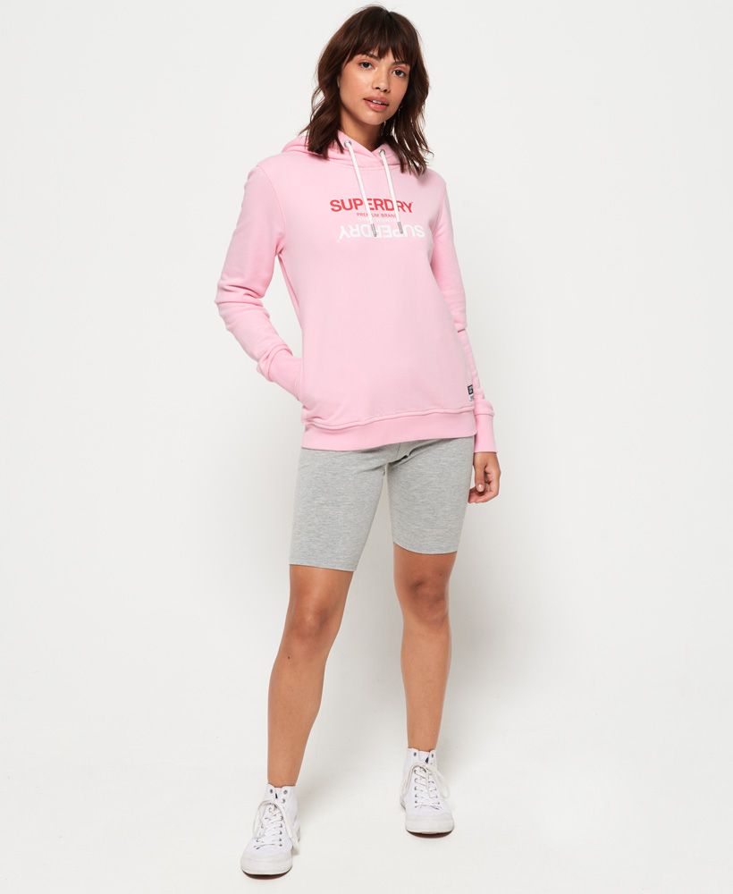 Superdry women's Gelsey hoodie. A classic wardrobe staple, this overhead hoodie features a drawstring hood, pockets in the side seams and a logo graphic on the chest. The Gelsey hoodie is completed with a logo patch above the hem.Slim fit
