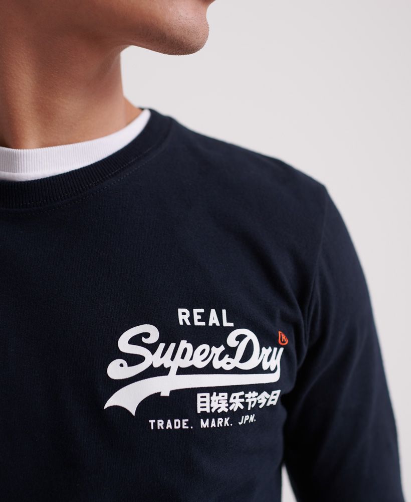 Superdry men's Vintage Logo Linear long sleeve t-shirt. This crew neck t-shirt features a textured Superdry logo on the chest and down the sleeve. Pair with jeans and a zip through hoodie for casual styling.