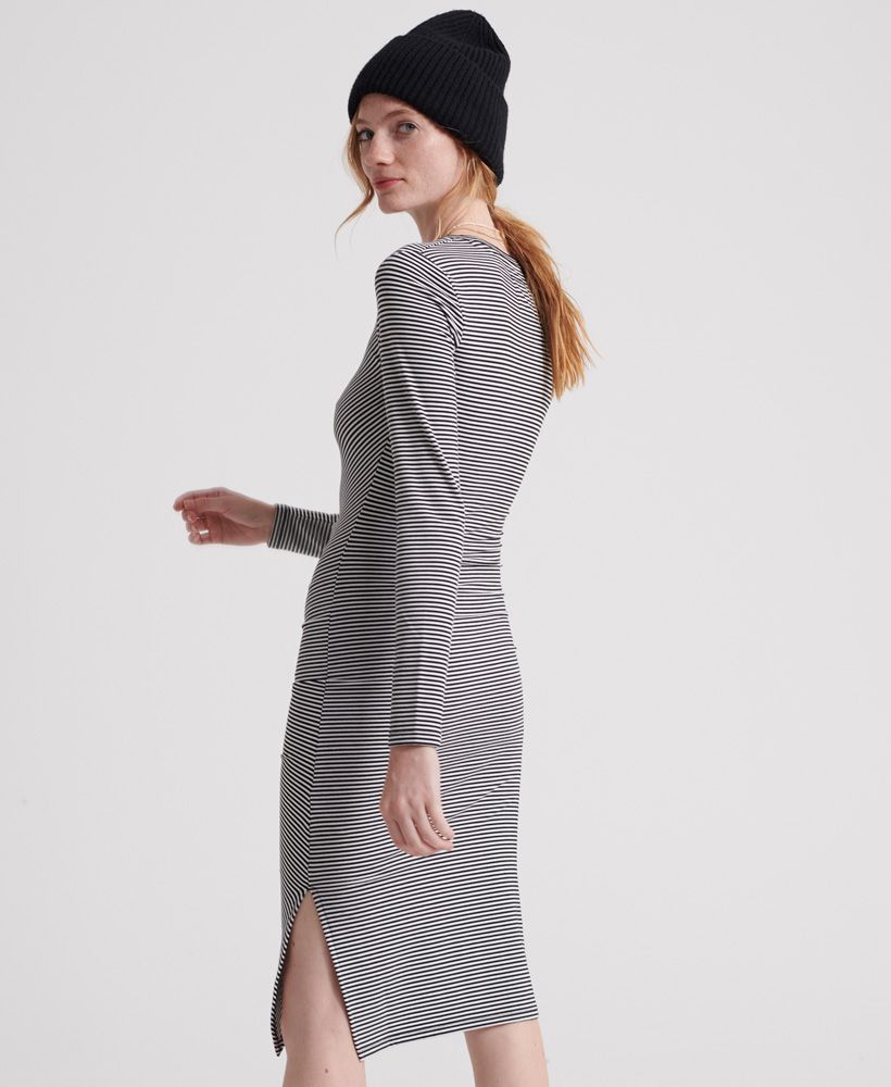 Superdry women's Rouched Midi long sleeved dress. This long sleeved midi dress features rouching down one side and a crew neckline. The dress is finished with a small split down the seam and a metal Superdry badge above the hem. Pair with your favourite ankle boots for a stylish look.