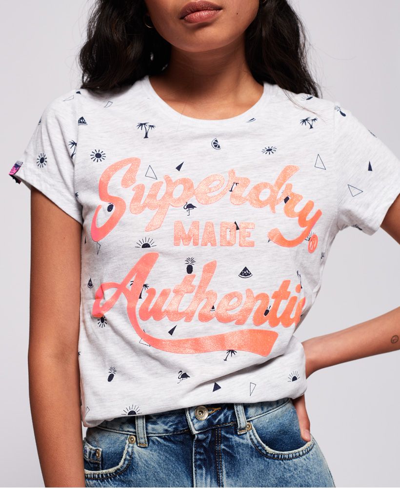 Superdry women's Made Authentic all over print T-shirt. This t-shirt features a classic crew neck with ribbed collar and short sleeves with an all over print design. Completed with a textured Superdry logo, a Superdry badge above the hem and a Superdry logo tab on one sleeve. Pair with jeans or shorts for a casual summer look.