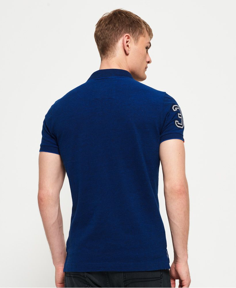 Superdry men's Classic pique polo shirt. This short sleeve polo shirt features a twin button fastening, split side seams and an embroidered version of our iconic logo on the chest. The polo is completed with an applique number graphic and logo tab on the right sleeve.Slim fitMade with Organic Cotton - Made using cotton grown using organic farming methods which minimise water usage and eliminate pesticides, maximising soil health and farmer livelihoods.