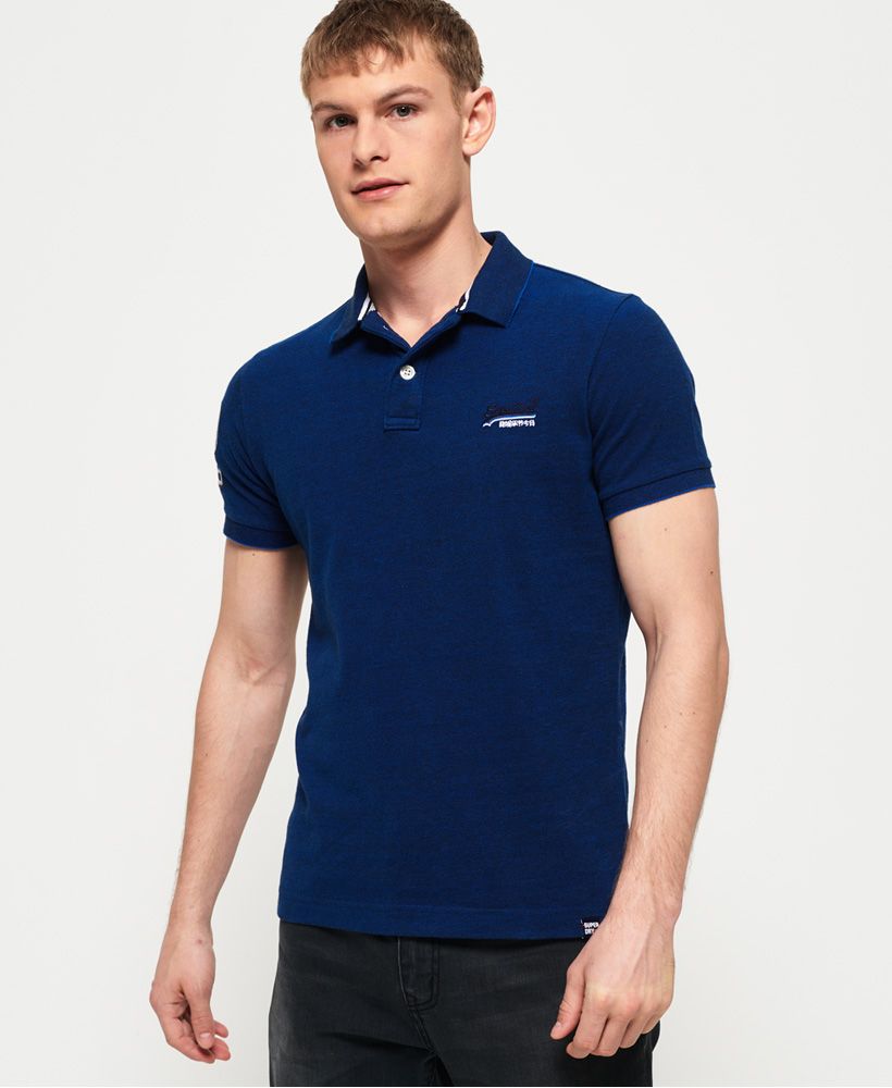 Superdry men's Classic pique polo shirt. This short sleeve polo shirt features a twin button fastening, split side seams and an embroidered version of our iconic logo on the chest. The polo is completed with an applique number graphic and logo tab on the right sleeve.Slim fitMade with Organic Cotton - Made using cotton grown using organic farming methods which minimise water usage and eliminate pesticides, maximising soil health and farmer livelihoods.