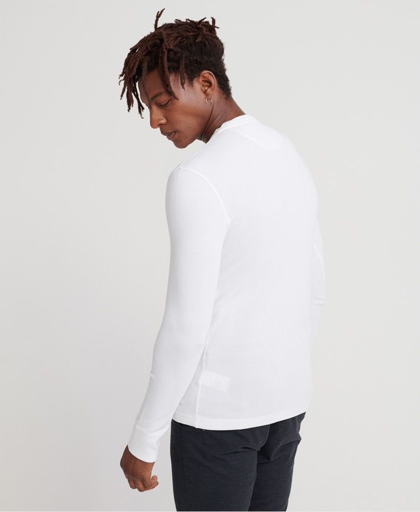 Superdry men's Edit long sleeved Henley top. This long sleeved top features a three button fastening and ribbed cuffs. Finished with a Superdry logo badge above the hem. Will look great paired with your favourite pair of jeans and a leather jacket this season.