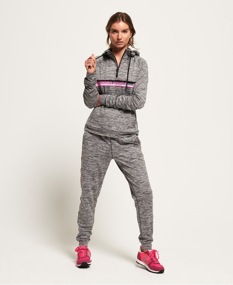 Superdry women's Core taped half zip hoodie. Combining style and comfort with technical performance, this hoodie has been crafted from a breathable fabric and uses moisture wicking technology to help keep you cool and comfortable as you smash your fitness goals. The hoodie features a drawstring hood with half zip fastening, a front pouch pocket and thumb holes in the cuffs. The hoodie is completed with Superdry Sport logo taping across the chest.Relaxed: A classic fit. Not too slim, not too tight – no distractions here