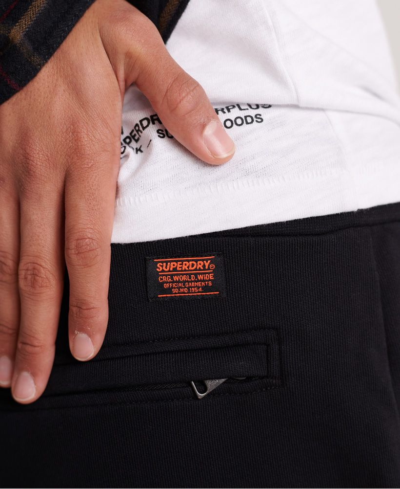 Superdry men's Rookie Utility Joggers. These comfy joggers feature a drawstring waist and three zip fastened pockets. Finished with a Superdry logo tab above the back pocket. Pair with your favourite trainers for a casual look.Relaxed fit