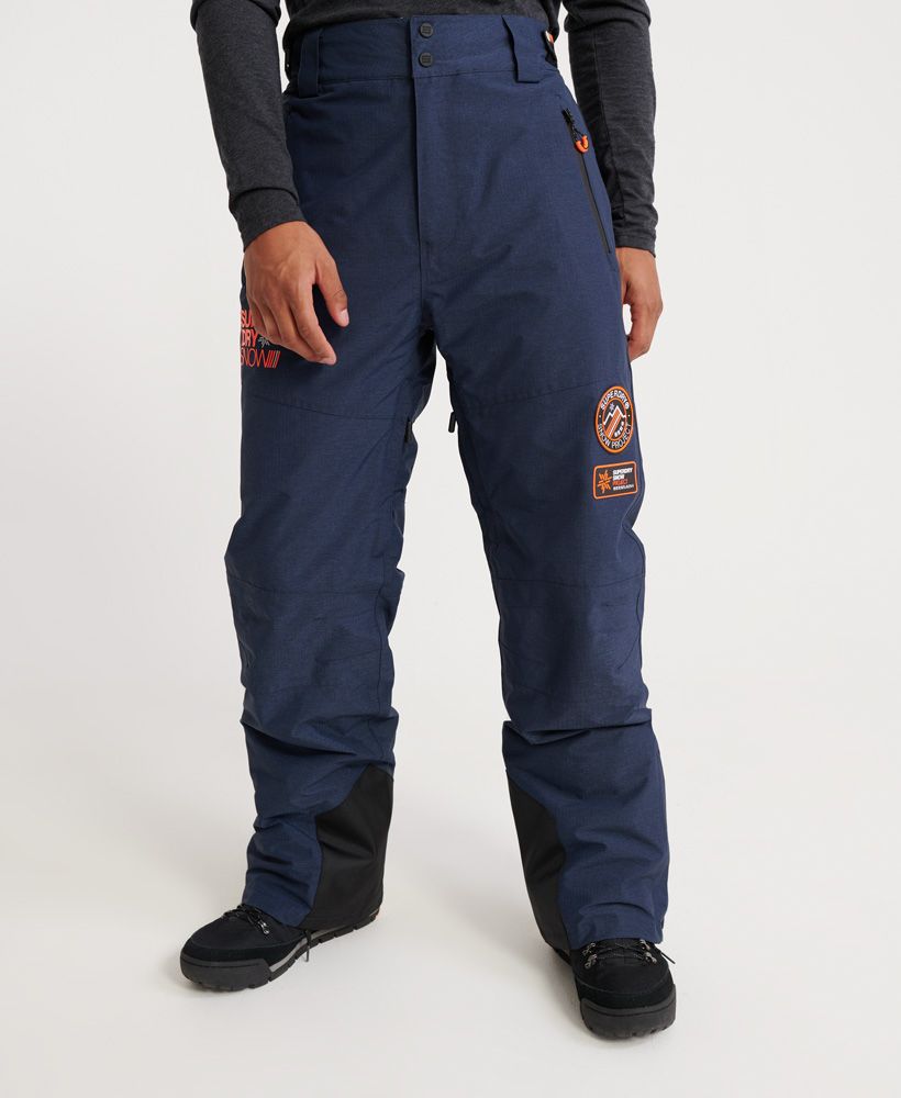 Superdry men’s Mountain Snow pants. These pants are a must-have on the slopes this season. Featuring a zip and popper fastening, hook and loop waist adjuster straps and thigh vents to keep you comfortable. These pant also feature zipped hems with boot gaiters. For practicality, these snow pants features two front zip pockets and two back pockets with popper fastenings. The Mountain snow pants are finished with branded zip pulls and poppers, a Superdry Snow logo on the upper thigh and two Superdry snow badges above the knee.Water resistant <10,000mmWind resistant <10,000g