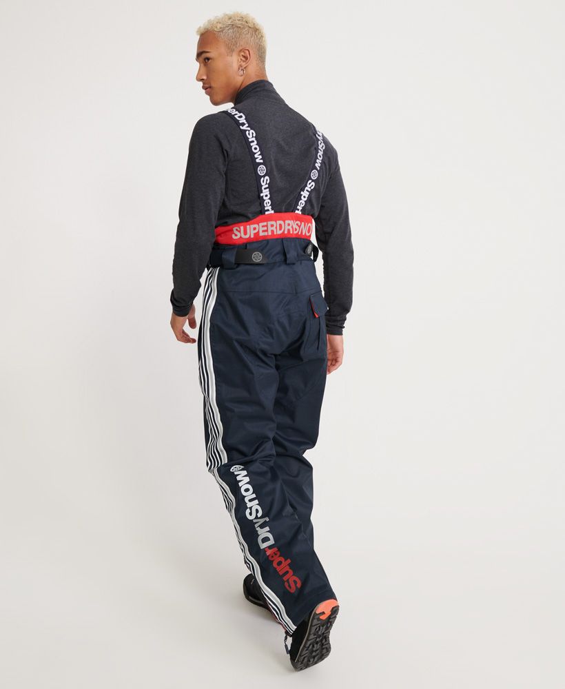 Superdry men’s Ultimate Snow Combat pants. These snow pants come with detachable, adjustable suspenders for a secure fit, a zip and popper fastening, hook and loop waist adjuster straps and leg length adjusters in the pockets for a personalised fit. These pants feature coated zips and thigh vents to keep you comfortable. These pants also feature zipped hems with boot gaiters and boot hooks. For practicality, these snow pants features two front zip pockets, and a hook and loop fastened back pocket. The Snow pants are finished with branded zip pulls and poppers, a Superdry Snow logo on the upper thigh and Superdry branding down the back of one leg.Water resistant <10,000mmWind resistant <10,000g
