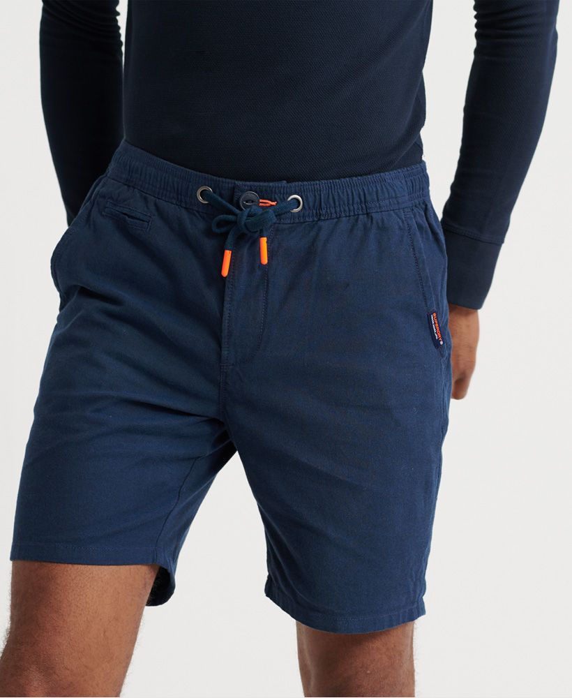 Superdry men's Sunscorched shorts. These shorts feature a zip and button fastening and the classic five pocket design with a button fastening on one back pocket. Adjust these shorts to fit with an elasticated drawstring waistband and one belt loop at the back. Complete with a Superdry logo tab on one front pocket and Superdry logo badge on the back.