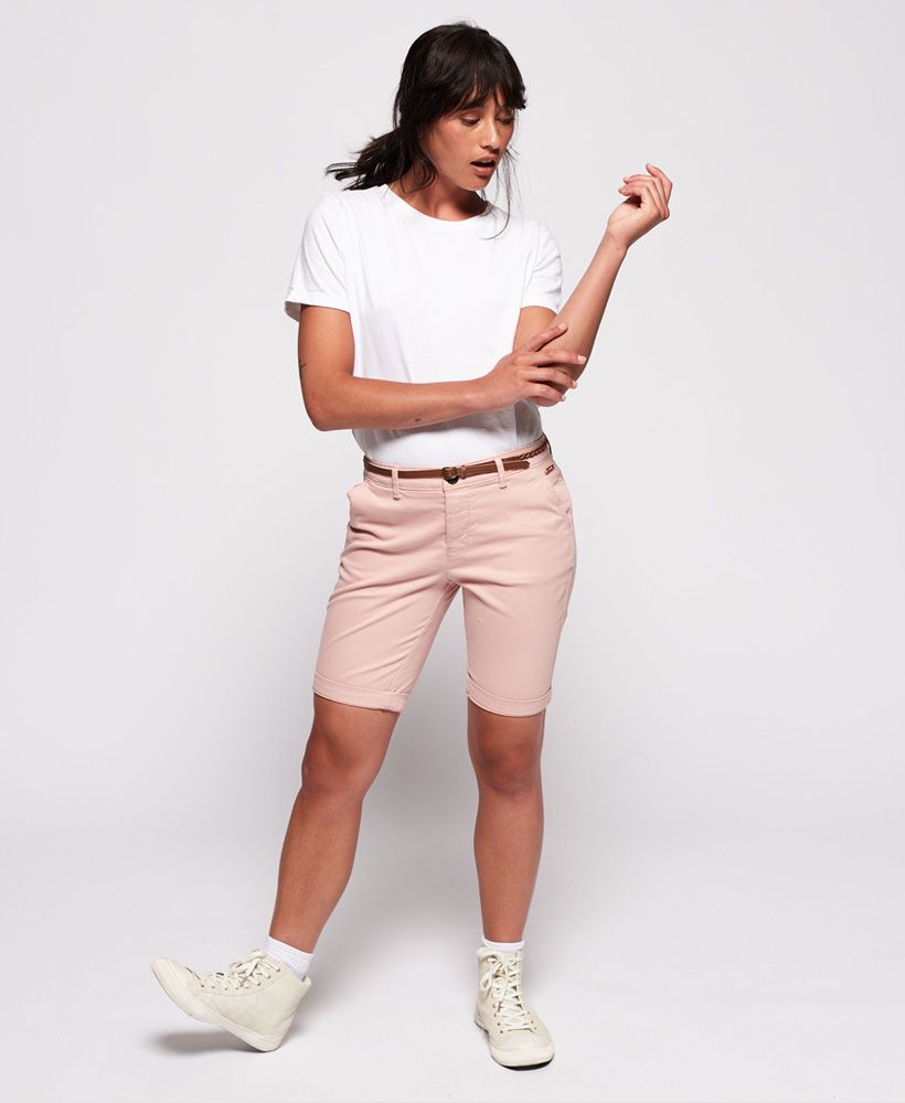Superdry women's Chino City shorts. A seasonal spin on a classic pair of chinos, these belted chino city shorts feature a button fly fastening, four pockets and turn up hems. Completed with a metal logo badge above one front pocket and logo badge above one back pocket.
