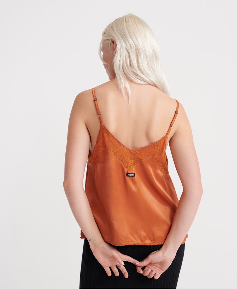 Superdry women's Nicolette Cami top. This silky feel cami top features adjustable straps, lace trim detailing and a flattering neckline. Finished with a metal Superdry logo bade to the hemline and a Superdry Outfitters logo tab to the back.