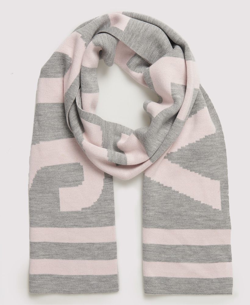 Superdry women's Superdry Urban Logo scarf. We've kept things contemporary with the Urban logo scarf this season. Featuring a large Superdry logo across the whole scarf and stripe detailing to the ends.
