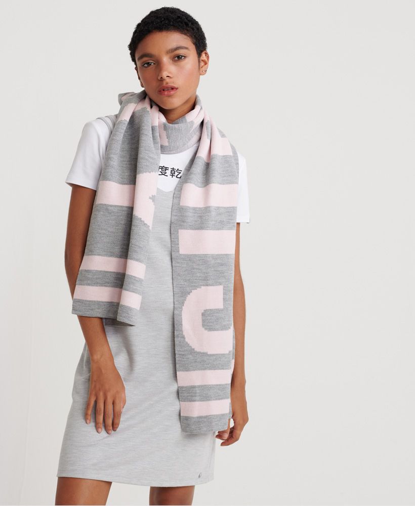 Superdry women's Superdry Urban Logo scarf. We've kept things contemporary with the Urban logo scarf this season. Featuring a large Superdry logo across the whole scarf and stripe detailing to the ends.