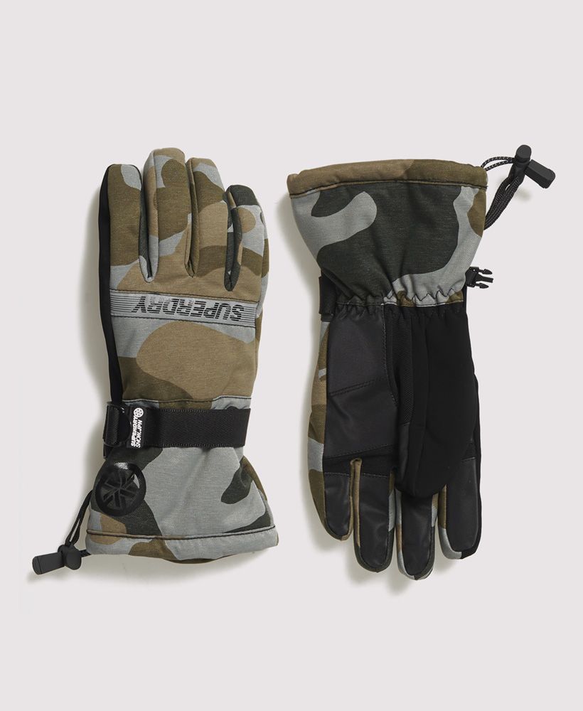 Superdry men's Ultimate snow rescue gloves. Our snow rescue gloves feature weather tolerant coated, highly breathable fabric with technical reinforced palms, a goggle wipe on the thumb and a super soft interior. These gloves also feature a bungee cord hem, a clip fastening around the wrist, a small clip to keep the pair together when not in use, and scratch resistant fingertips. All finished with Superdry branding at the top of the glove and by the wrist.