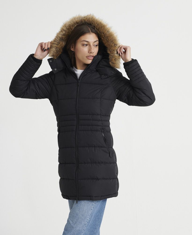 Superdry women's Kumano Ultimate parka coat. Stay warm this season with the Kumano Ultimate parka coat. This features a faux fur trimmed hood with popper fastening, ribbed collar with full zip fastening, ribbed cuffs and zip fastening on the sleeves for extra warmth. This quilted coat is finished with two front zipped pockets for storing essentials and a Superdry Mountain badge stitched onto one sleeve.
