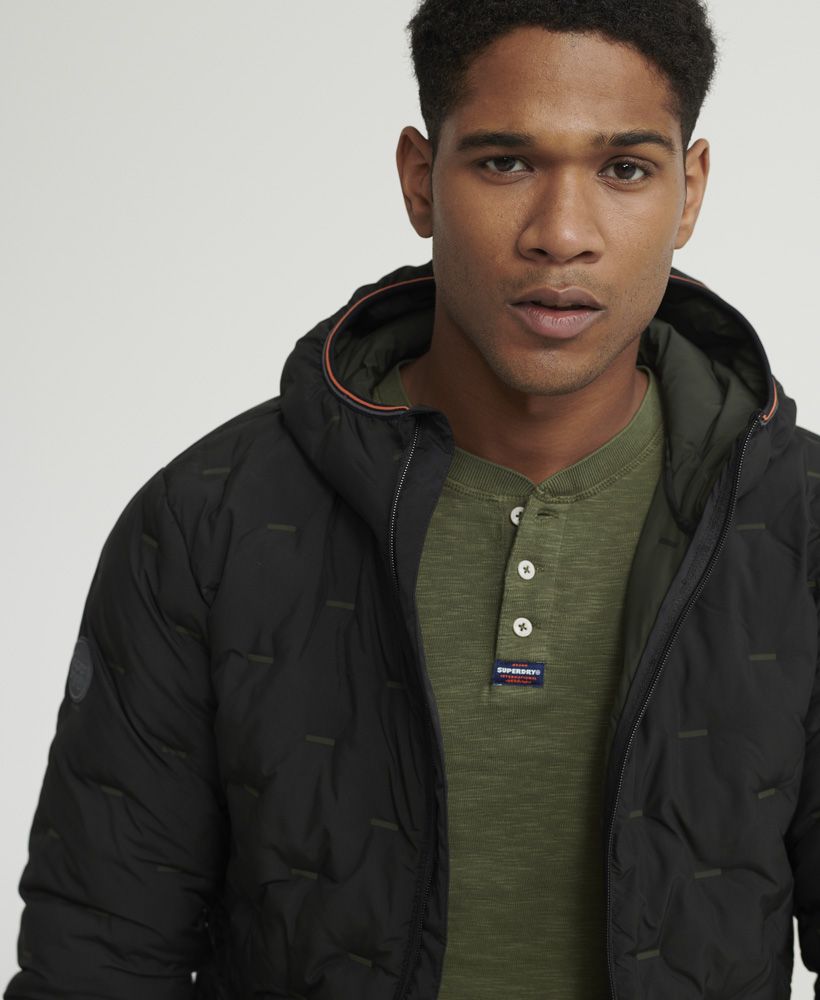 Superdry men's Legacy long sleeve Henley top. A long sleeved top featuring Henley collar with button fastening, and ribbed cuffs. Finished with a Superdry logo patch on the placket, this top is ideal for pairing with jeans or chinos for a smart casual look.