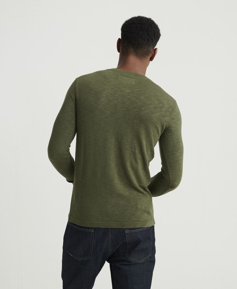 Superdry men's Legacy long sleeve Henley top. A long sleeved top featuring Henley collar with button fastening, and ribbed cuffs. Finished with a Superdry logo patch on the placket, this top is ideal for pairing with jeans or chinos for a smart casual look.