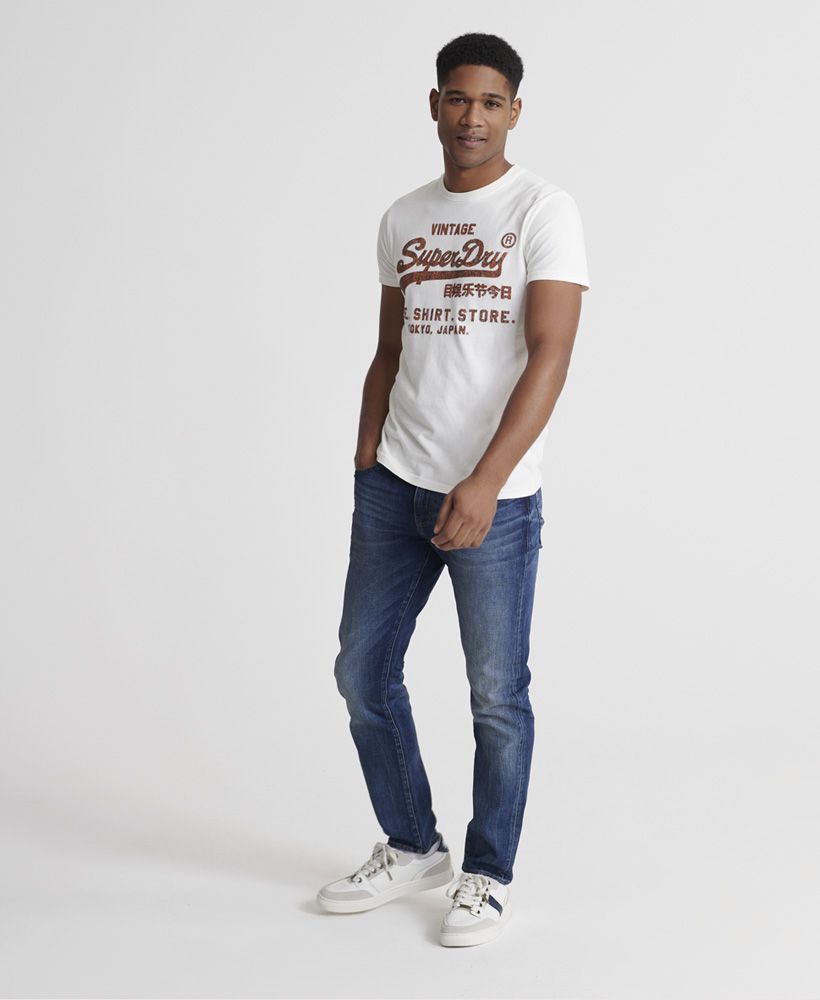 Superdry men's Vintage Logo Bonded T-Shirt. Part of our Shirt Shop range this classic Superdry tee features, a ribbed crew neck collar and finished with a textured Superdry bonded Vintage logo on the chest.Slim fit – designed to fit closer to the body for a more tailored look
