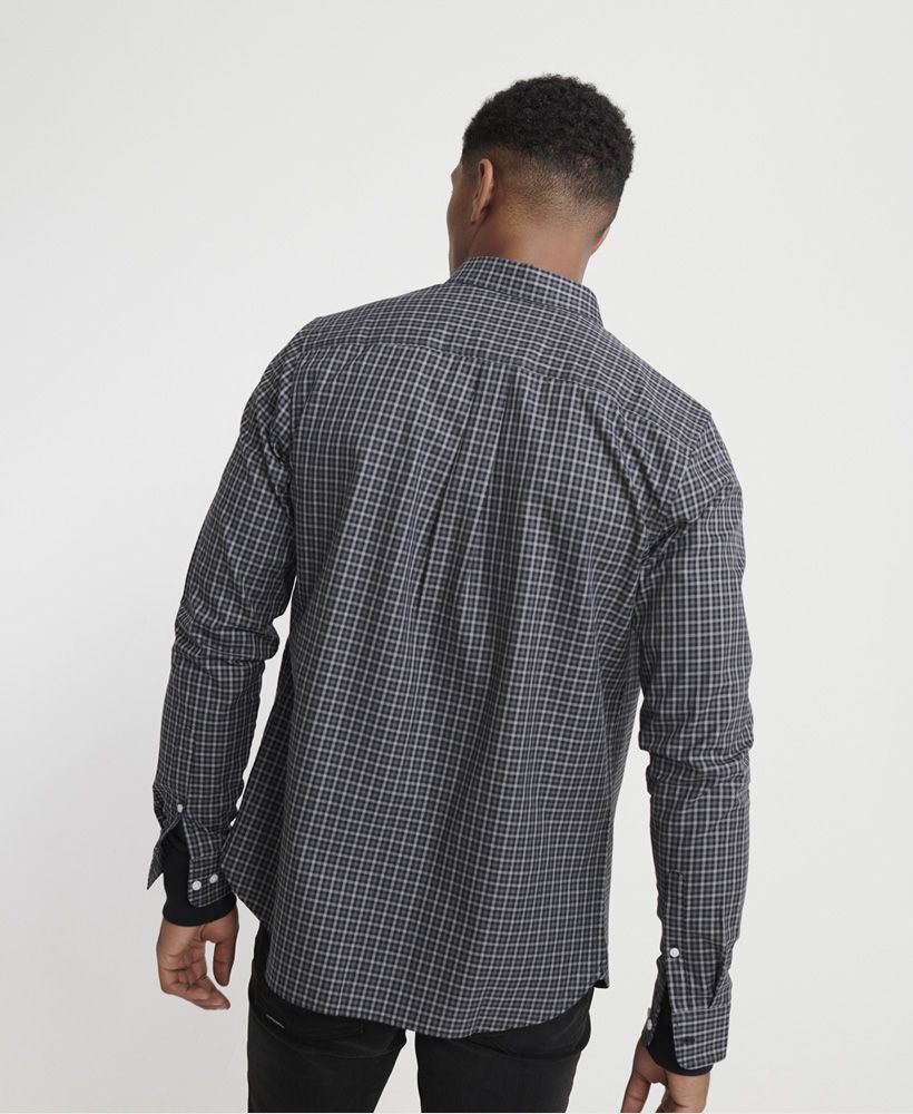 Superdry men's Classic London long sleeved shirt. A classic 100% cotton shirt that features a button down fastening, button fastened cuffs and a single chest pocket. Completed with an embroidered Superdry logo on the pocket and a Superdry logo badge on the placket.
