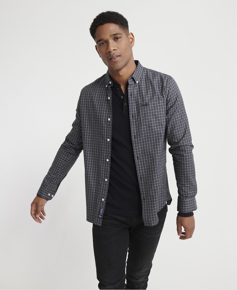 Superdry men's Classic London long sleeved shirt. A classic 100% cotton shirt that features a button down fastening, button fastened cuffs and a single chest pocket. Completed with an embroidered Superdry logo on the pocket and a Superdry logo badge on the placket.