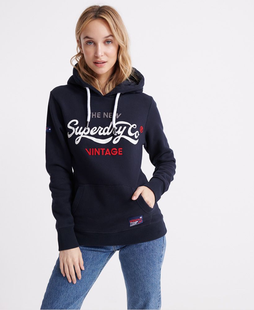 Superdry women's Vintage Uni hoodie. An overhead hoodie featuring a drawstring hood. a large pouch pocket and ribbed cuffs and hem. Completed with a cracked print Superdry vintage logo across the chest and a Superdry logo patch on the pocket.