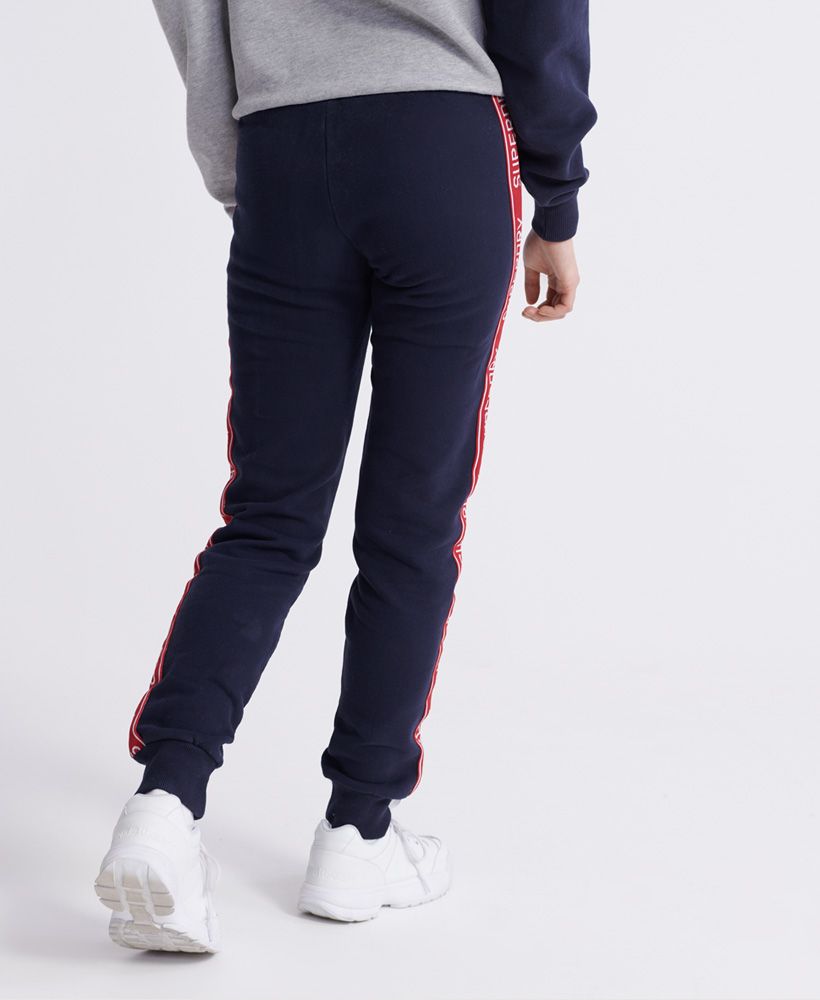 Superdry women's Orla cuffed joggers. Ideal for leisure or lounging, these joggers feature an elasticated drawstring waistband, ribbed cuffs and are finished with Superdry logo branding down each leg and branded aglets.Relaxed fit