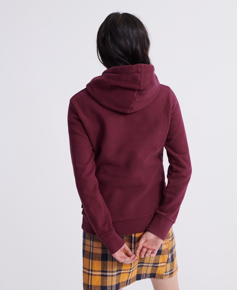 Superdry women's Tokyo 7 embossed hoodie. A classic pullover style hoodie, featuring ribbed cuffs and hem, a front pouch pocket and a drawstring hood. Completed with an embossed Superdry logo across the chest and Superdry tab on the side seam.Slim fit