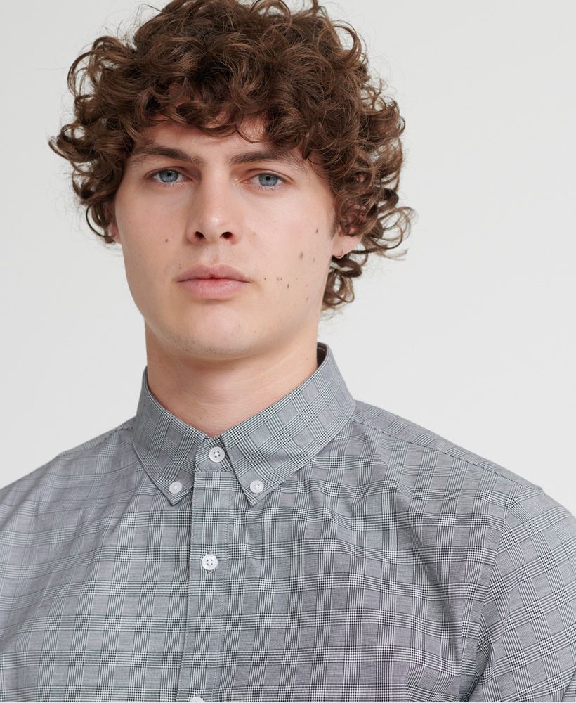 Superdry men's Edit button down shirt. Look the part in this regular fit formal shirt which features a classic button down collar and a single box pleat in the back for added comfort. Finished with Superdry branded buttons, and an embroidered S on the side seam.