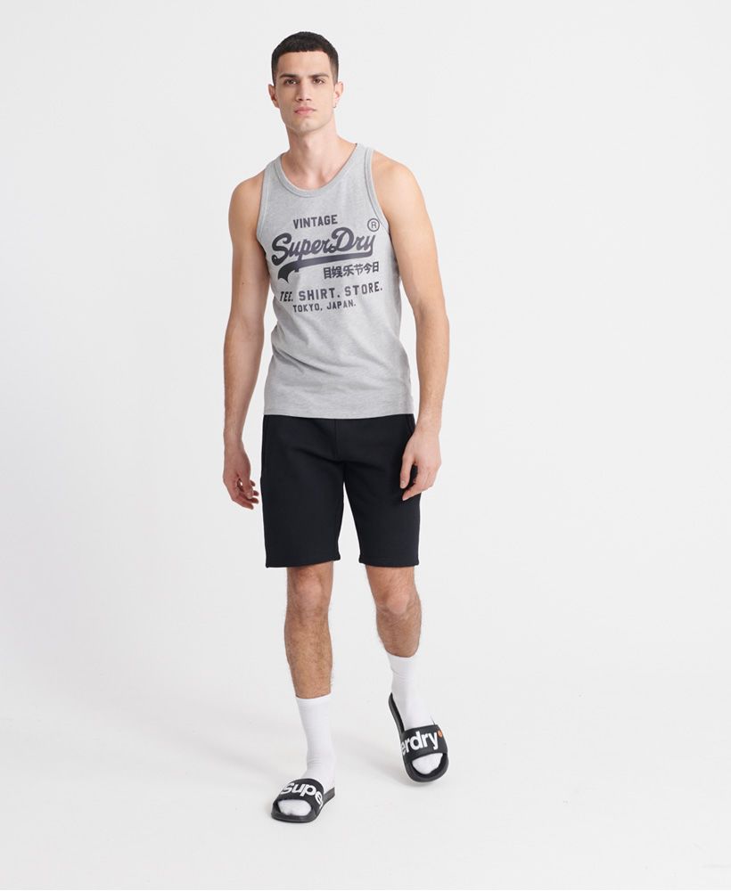 Superdry men's Vintage Logo bonded vest top. This sleeveless crew neck top features ribbed trims and is finished with a textured Superdry print across the front.