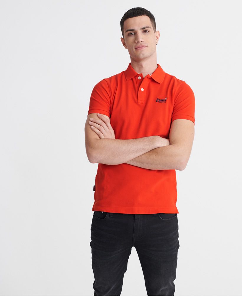 Superdry men's Classic pique short sleeve polo shirt. This classic style polo shirt features a half button fastening, short sleeves and reinforced side splits. Completed with a Superdry logo tab on the side seam and an embroidered Superdry logo on the chest.Made with Organic Cotton - Grown using only organic inputs and no artificial chemicals, which leads to improved soil condition, stronger biodiversity and better health among the cotton growers and uses between 60-90% less water to grow. By 2030, all Superdry Cotton will be Organic.Slim fit