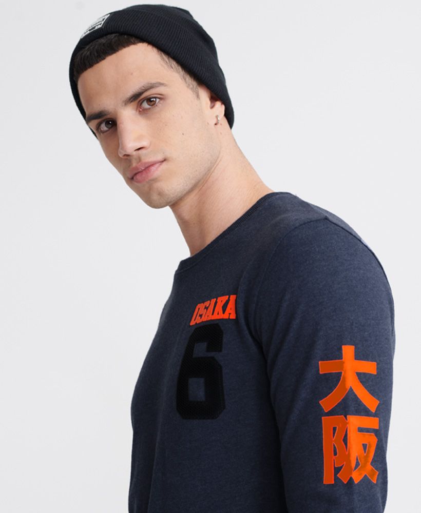 Superdry men's Osaka Series top. This long sleeved top features a crew neckline, and textured Osaka prints down the arm and across the back. Finished with a rubber Osaka 6 logo on the chest.